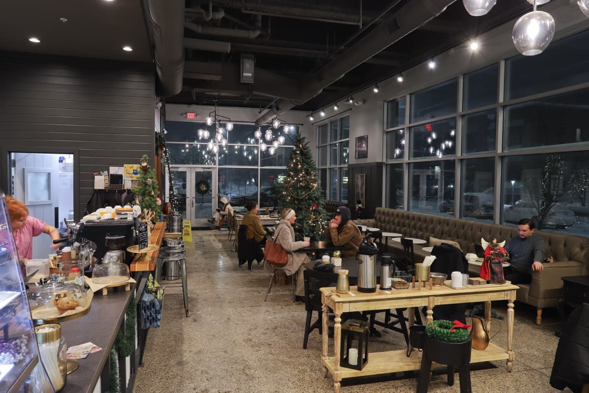 Espresso bar with barista and warm lighting