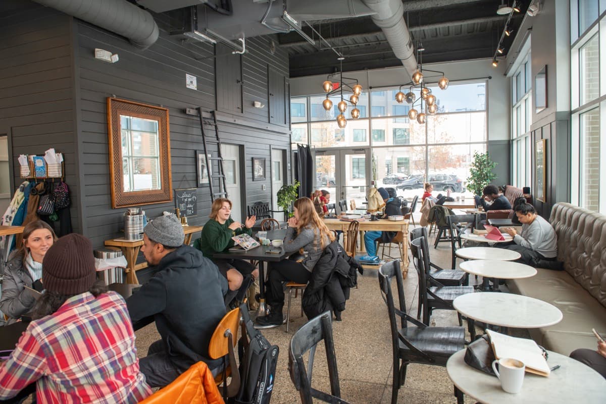 Daytime cafe scene with customers studying and socializing