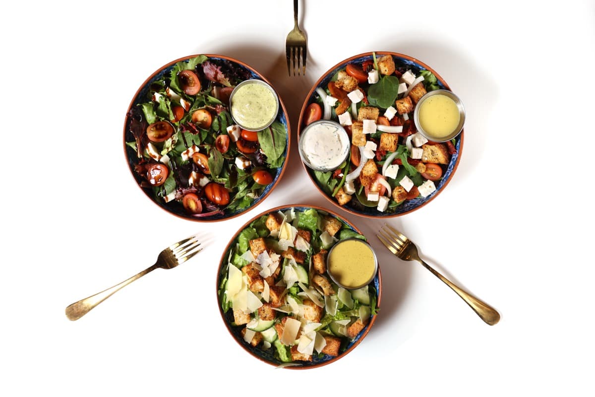 Three fresh salads with house-made dressings